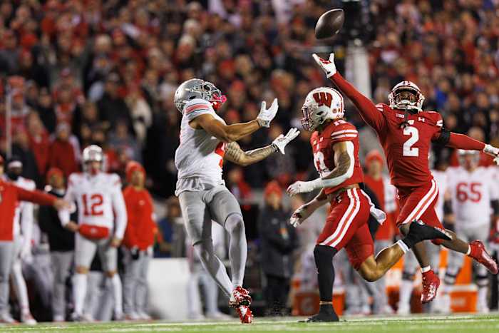 Oct 28, 2023; Madison, Wisconsin, USA; Wisconsin Badgers cornerback Ricardo Hallman (2) defends the pass intended for Ohio State Buckeyes wide receiver Julian Fleming (4) during the first quarter at Camp Randall Stadium. Mandatory Credit: Jeff Hanisch-USA TODAY Sports